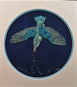 Kingfisher swooping down on dark blue silk